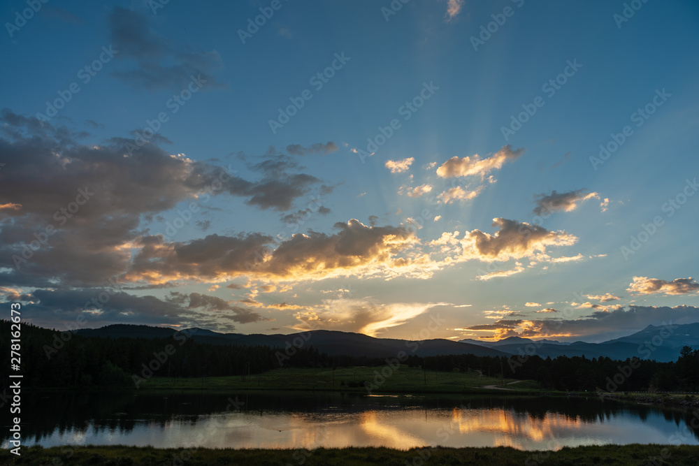 Sunset over a small Lake in the Colorado Rocky Mountains, known as Los Lagos Reservoir Number three. Near Kelly Dahl Campground and the Town of Nederland, CO.