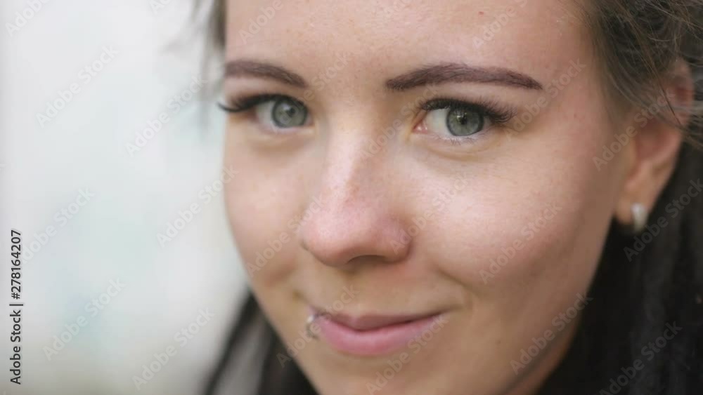 closeup portrait of attractive girl with dreadlocks smiling and looking at the camera closeup portrait of attractive girl with dreadlocks smiling and looking at the camera
