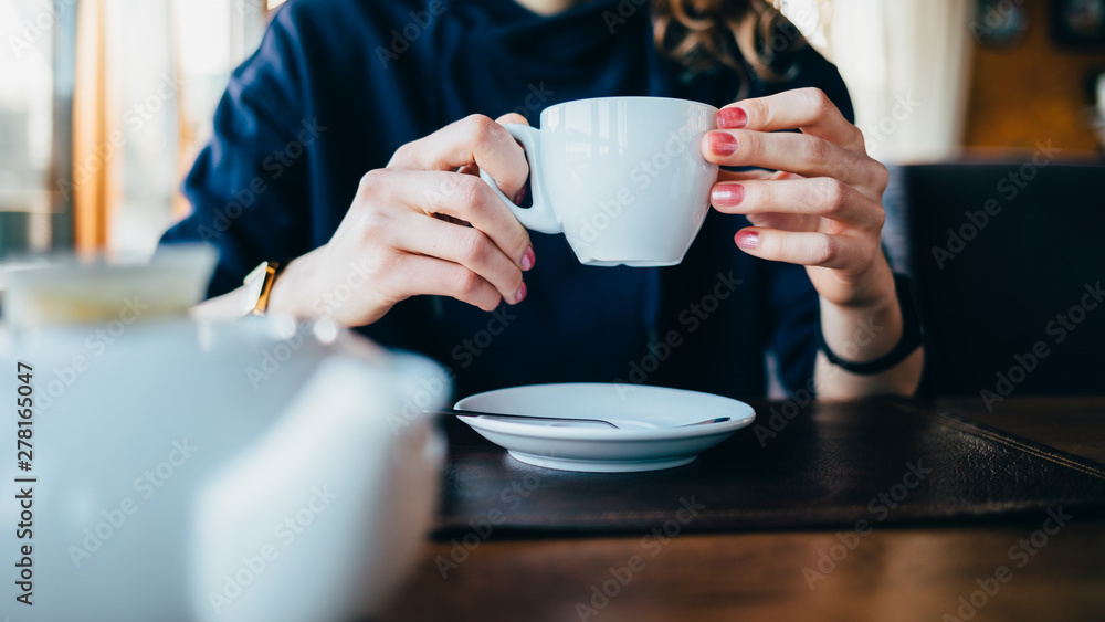 Female's hands holding cup of tea Female's hands holding cup of tea