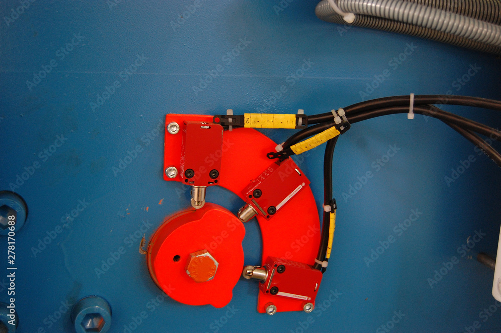 a fragment of an industrial machine with a cam mechanism and limit switches a fragment of an industrial machine with a cam mechanism and limit switches