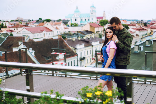 Couple in love , standing on roof of house