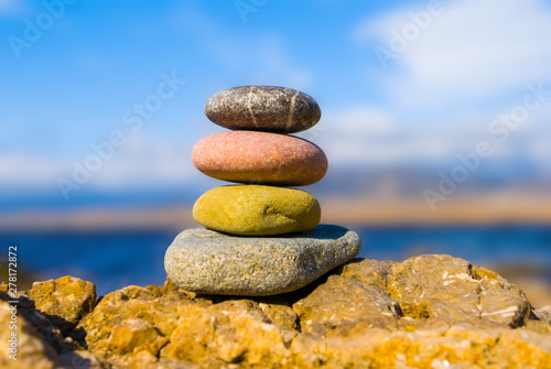 closeup heap of varicoloured pebbles on a sea coast