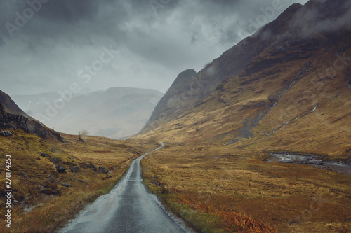 Beautiful scenic road in Glen Etive, Glen Coe Scotland. Skyfall landscape in rainy foggy weather. photo