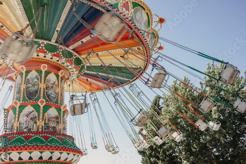 Carousel with chains in an amusement park on a summer sunny day