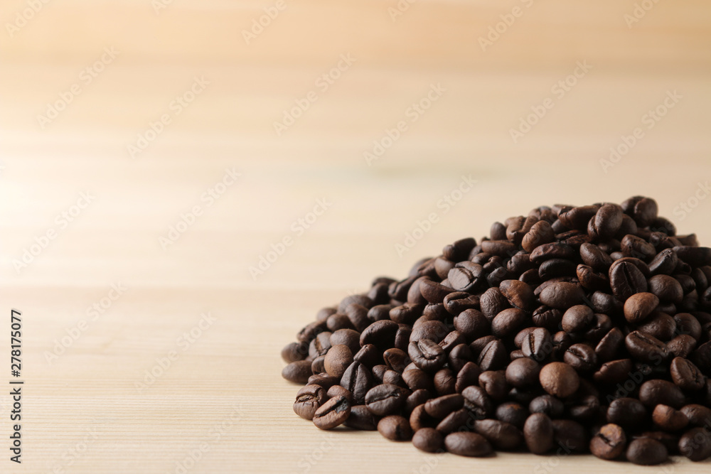 Fototapeta premium roasted coffee beans on a natural wooden table. Frame of coffee beans Robusta, Arabica. space for text