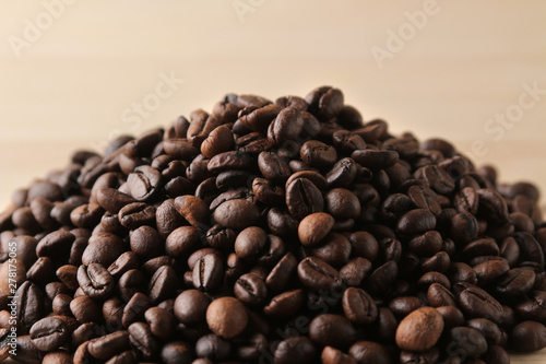 Roasted coffee grains close-up on a brown wooden background. Robusta  Arabica.