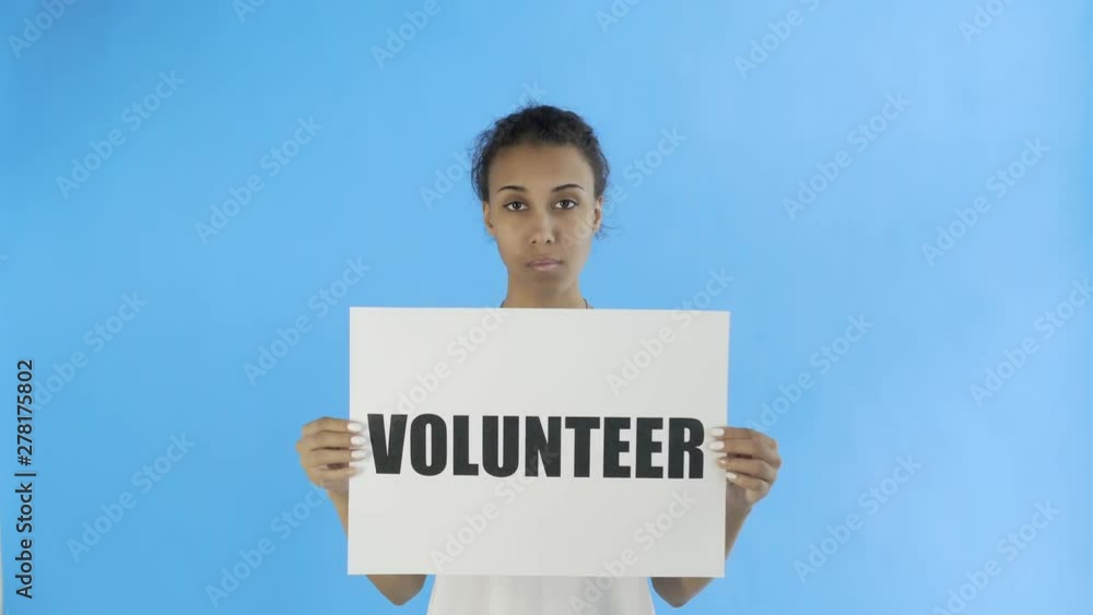 Afro-American Girl Activist With Volunteer Poster on blue background Afro-American Girl Activist With Volunteer Poster on blue background
