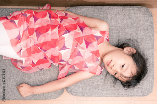 Chinese girls lying on Grey sofa cushions