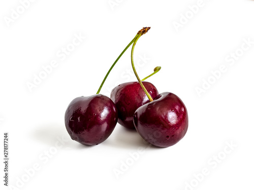 Three sweet cherry on white background