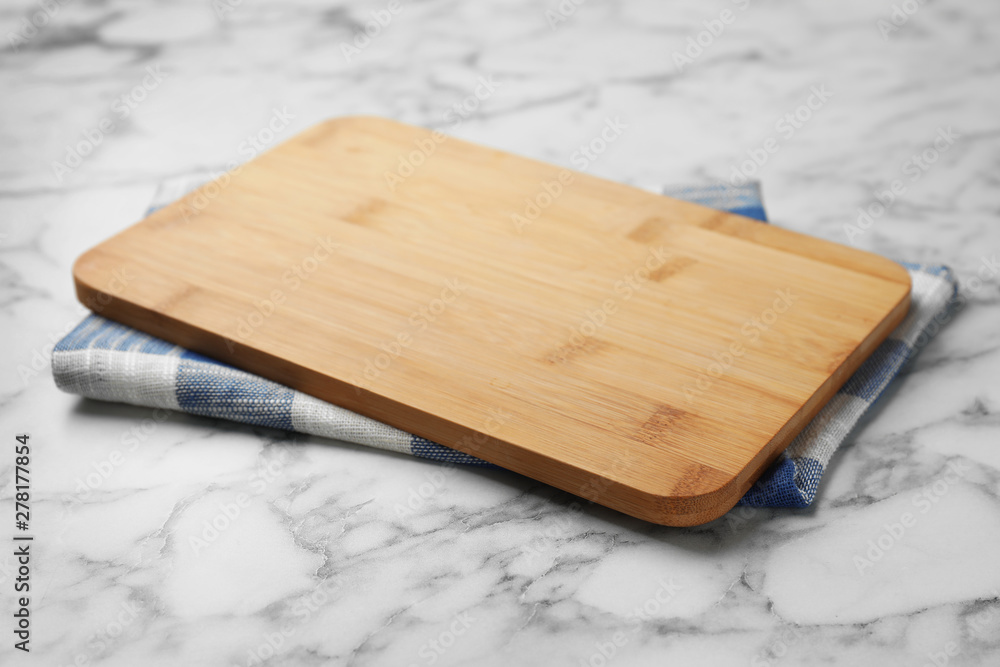 Fototapeta premium Wooden board and kitchen towel on marble table