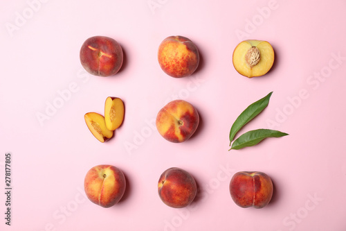 Flat lay composition with sweet juicy peaches on pink background