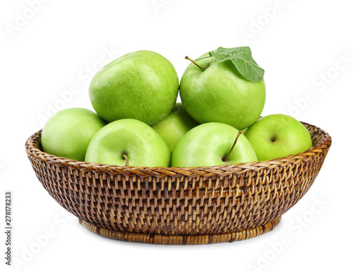 Wicker bowl of fresh green apples on white background