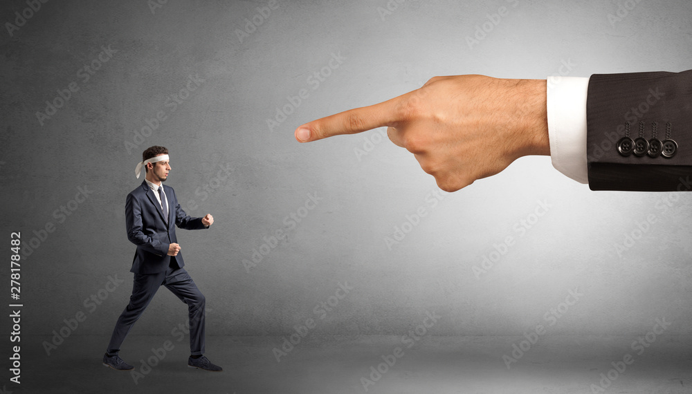 Small karate man fighting with big hand Small karate man fighting with big hand