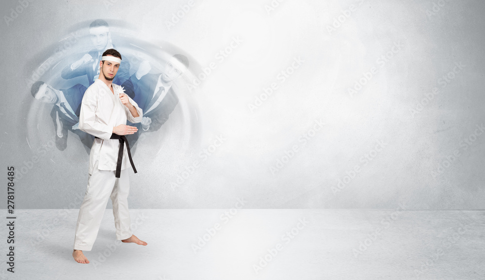 Young businessman in suit fighting with empty wall background Young businessman in suit fighting with empty wall background