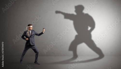 Young karate man confronting with his own shadow © ra2 studio