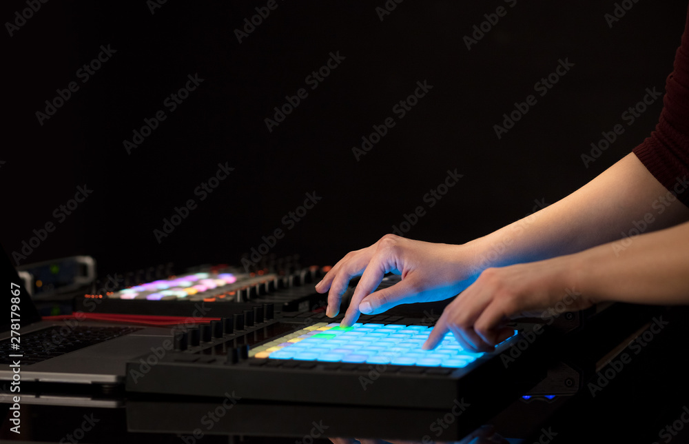 Dj hand remixing music on midi controller Dj hand remixing music on midi controller