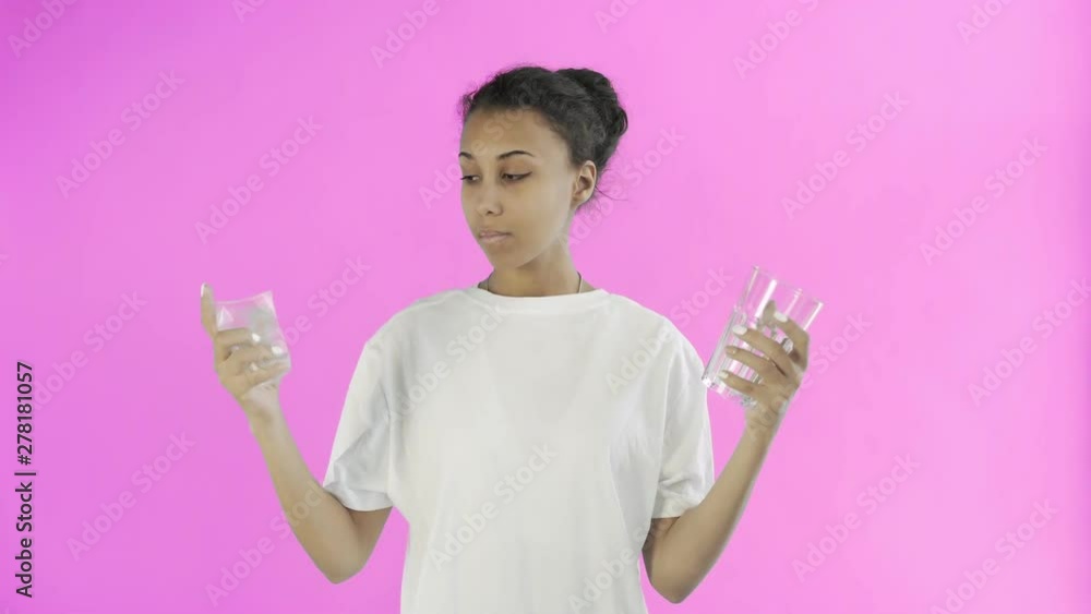 Afro-American Girl Activist With plastic and glass cups on pink background Afro-American Girl Activist With plastic and glass cups on pink background