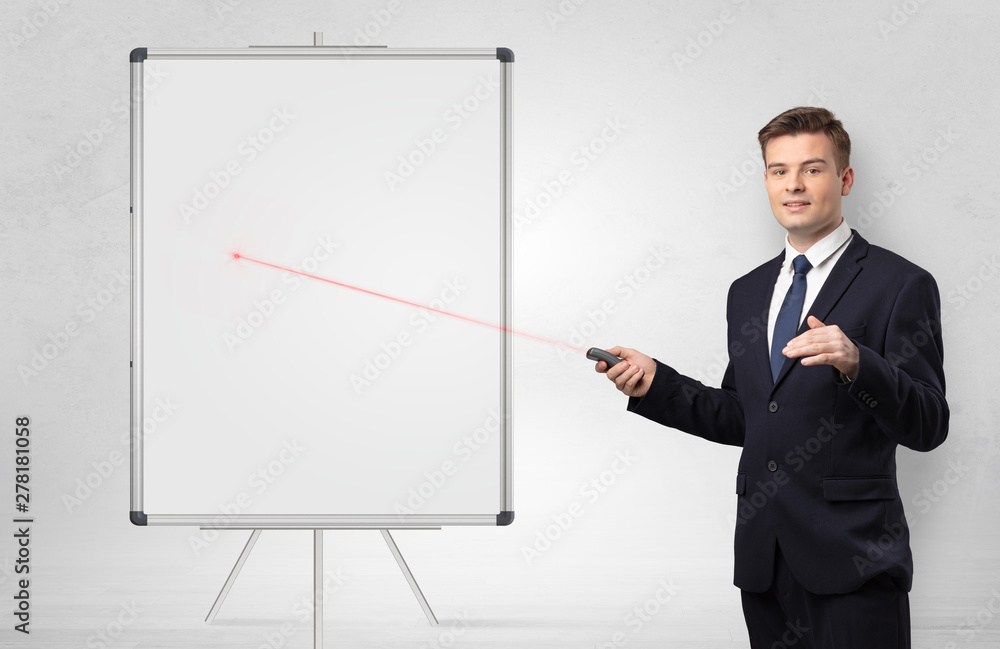 Young businessman with laser pointer and copyspace white blackboard Young businessman with laser pointer and copyspace white blackboard