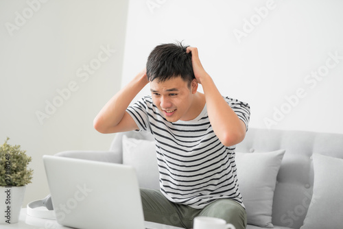 Depressed young man checking home finance