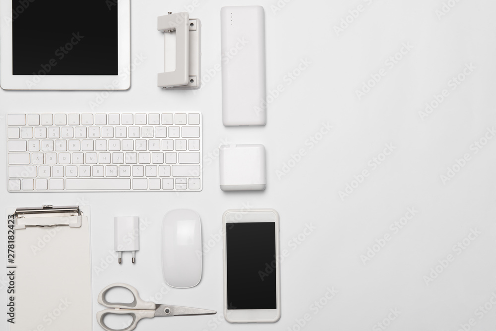 Mix of office supplies and gadgets on white background Mix of office supplies and gadgets on white background