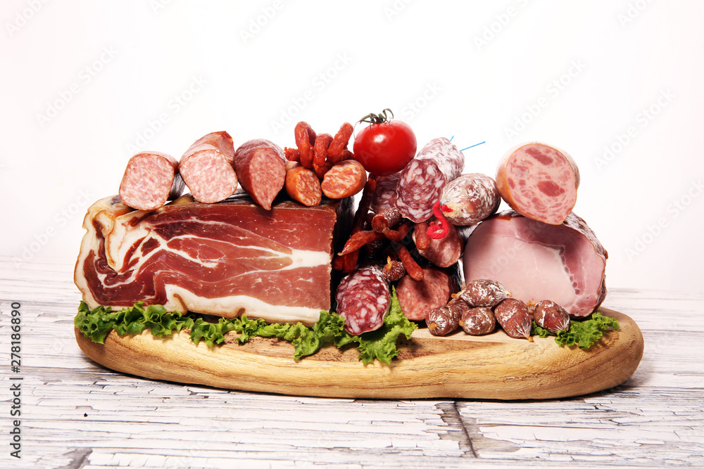 cold meat assortment with delicious salami and fresh herbs . Variety of meat products including proscuitto, jamon and sausages cold meat assortment with delicious salami and fresh herbs . Variety of meat products including proscuitto, jamon and sausages