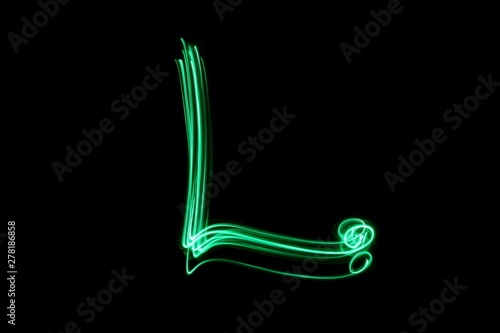 Long exposure photograph, light painting photography.  Letter l of an alphabet series, single letter, in neon green light, against a black background photo