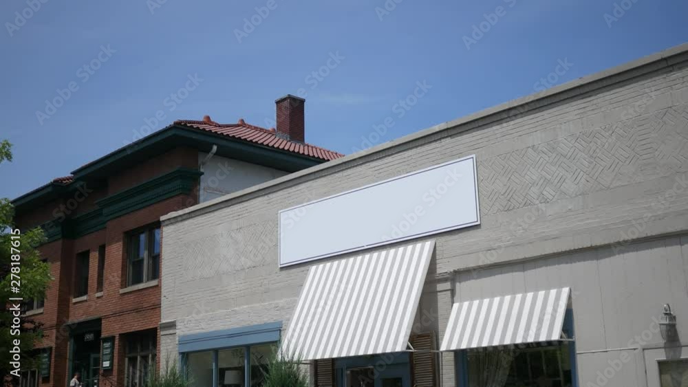 Establishing shot of tan bricked business with generic blank signage for replacement Establishing shot of tan bricked business with generic blank signage for replacement