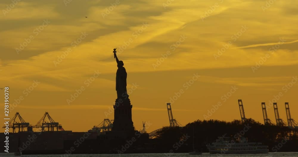 Silhouette of Famous Impressive New York Statue of Liberty On Iconic Hudson River In Beautiful NYC Silhouette of Famous Impressive New York Statue of Liberty On Iconic Hudson River In Beautiful NYC
