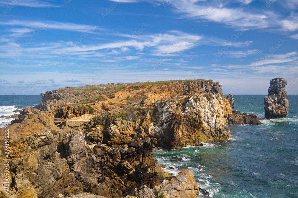 The rocky peninsula in the ocean with a small cliff on the side. Portugal. Europe Peniche