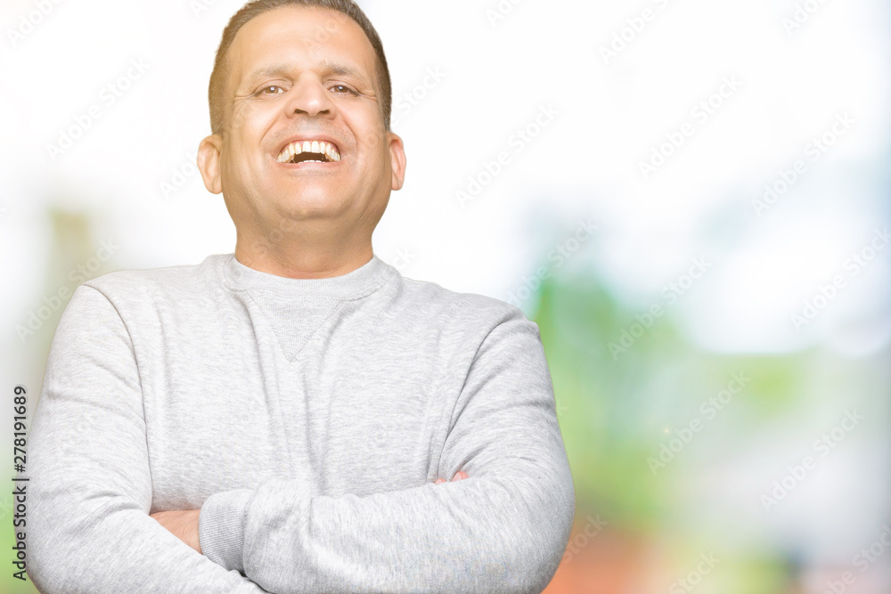 Middle age arab man wearing sport sweatshirt over isolated background happy face smiling with crossed arms looking at the camera. Positive person. Middle age arab man wearing sport sweatshirt over isolated background happy face smiling with crossed arms looking at the camera. Positive person.