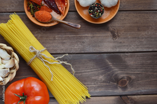 dried pasta on a wooden background with spices