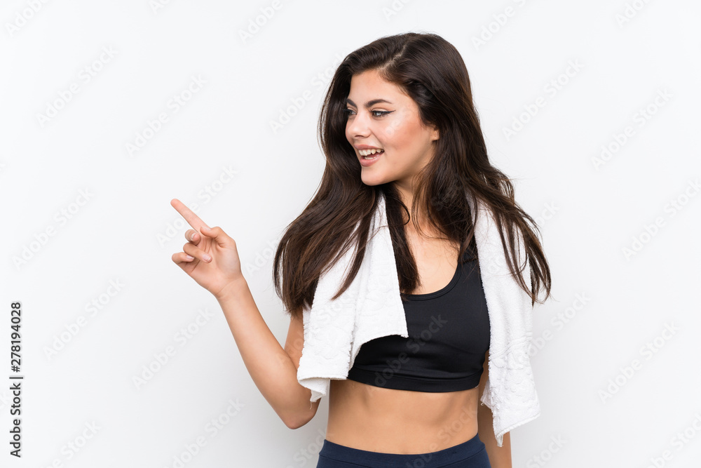 Teenager sport girl over isolated white background pointing finger to the side Teenager sport girl over isolated white background pointing finger to the side