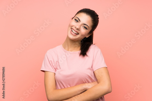 Teenager girl over isolated pink background laughing