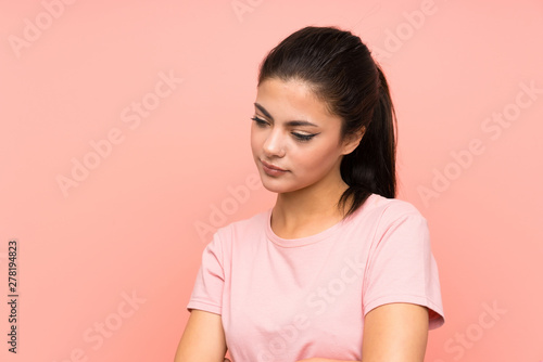 Teenager girl over isolated pink background standing and thinking an idea