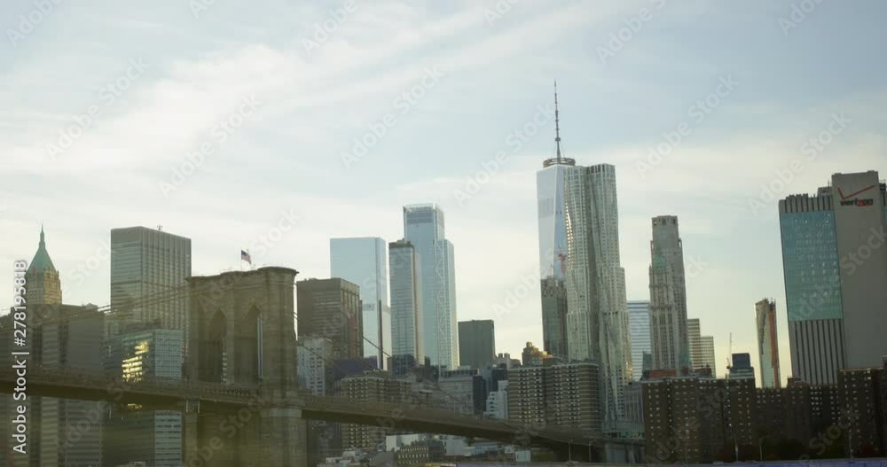 Slow Motion Iconic New York Skyline With Classic Brooklyn Bridge In the Classic Financial District On Hudson River And Impressive World Trade Centre And Waving American Flag Slow Motion Iconic New York Skyline With Classic Brooklyn Bridge In the Classic Financial District On Hudson River And Impressive World Trade Centre And Waving American Flag