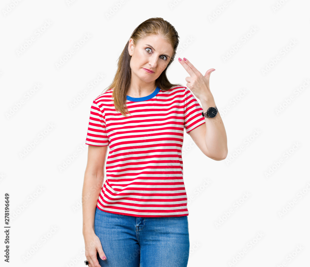 Middle age mature woman wearing casual t-shirt over isolated background Shooting and killing oneself pointing hand and fingers to head, suicide gesture. Middle age mature woman wearing casual t-shirt over isolated background Shooting and killing oneself pointing hand and fingers to head, suicide gesture.