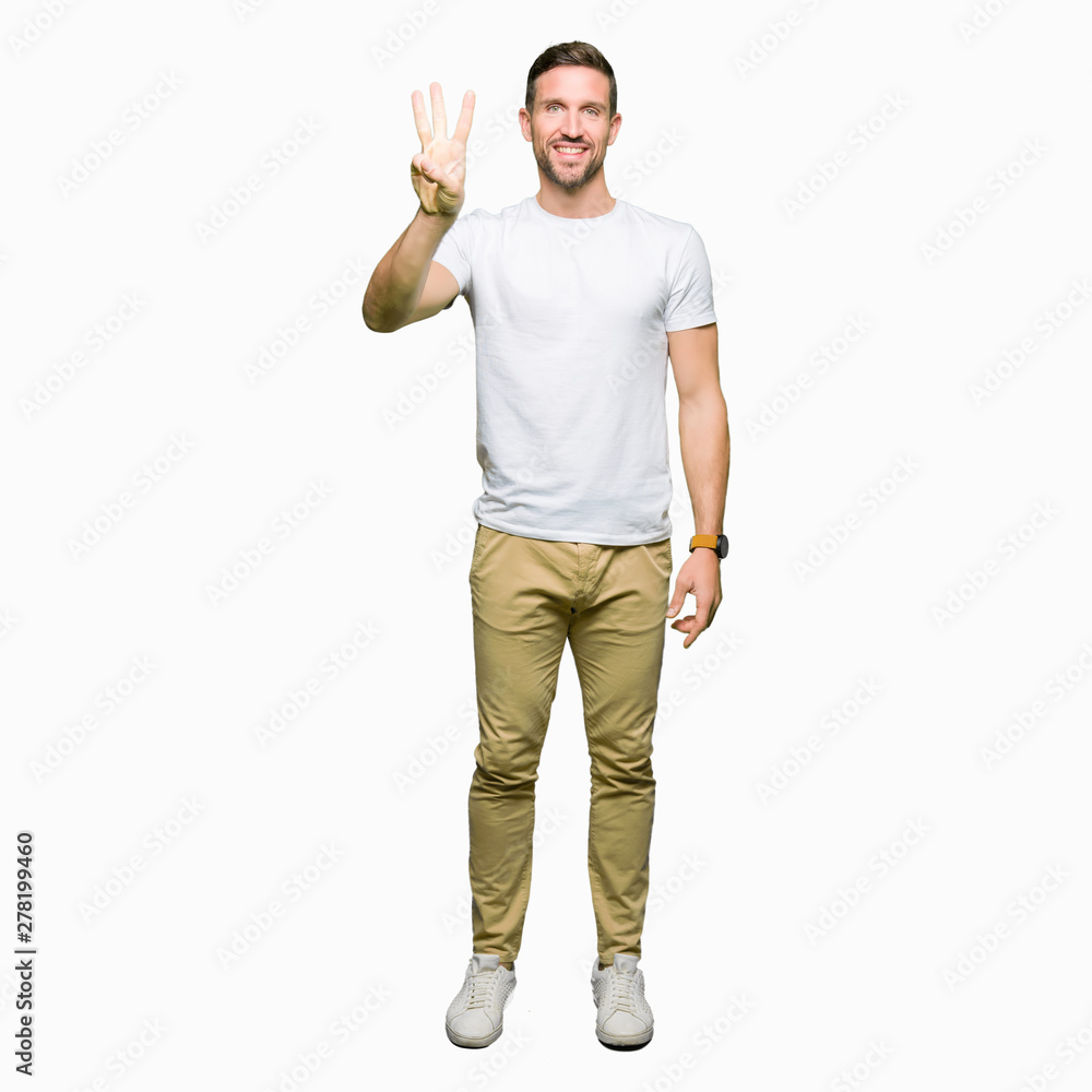 Handsome man wearing casual white t-shirt showing and pointing up with fingers number three while smiling confident and happy. Handsome man wearing casual white t-shirt showing and pointing up with fingers number three while smiling confident and happy.