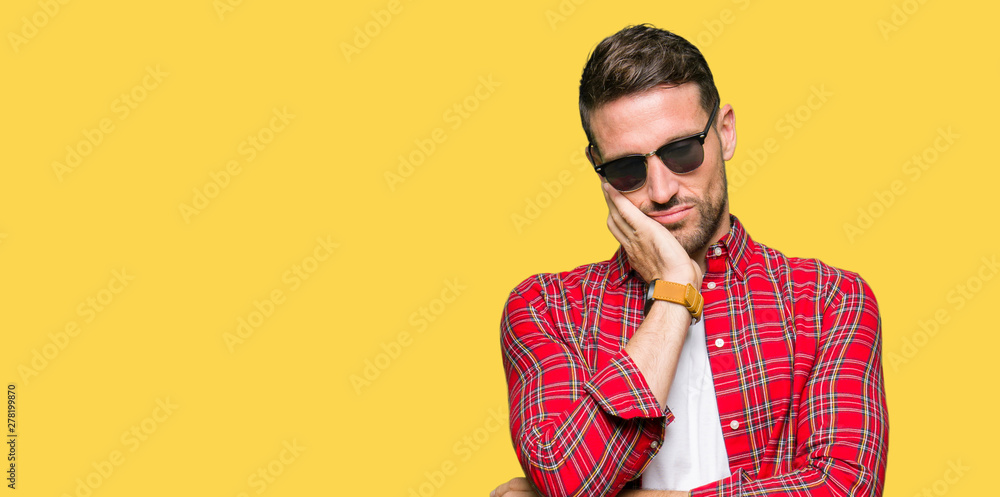 Obraz premium Handsome man wearing fashion sunglasses thinking looking tired and bored with depression problems with crossed arms.