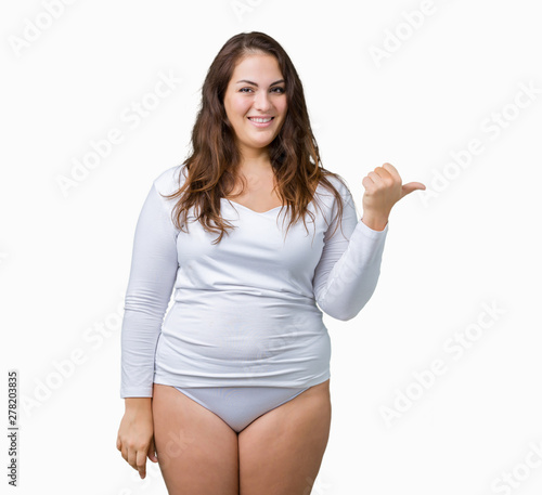 Konstfotografi Beautiful plus size young overwight woman wearing white underwear over isolated background smiling with happy face looking and pointing to the side with thumb up