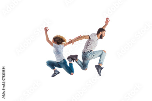 Two people jumping in air