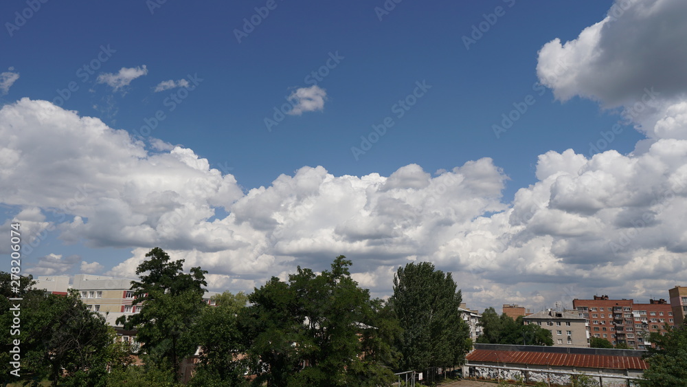 Blue sky with a clouds in a clear day over city background