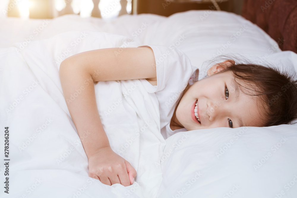 Chinese girl in white dress lying in bed Chinese girl in white dress lying in bed