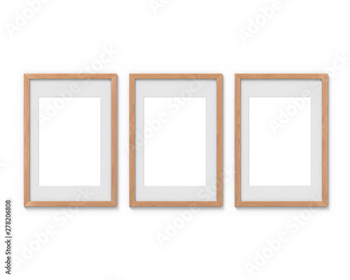 Set of 3 vertical wooden frames mockup with a border hanging on the wall. Empty base for picture or text. 3D rendering.