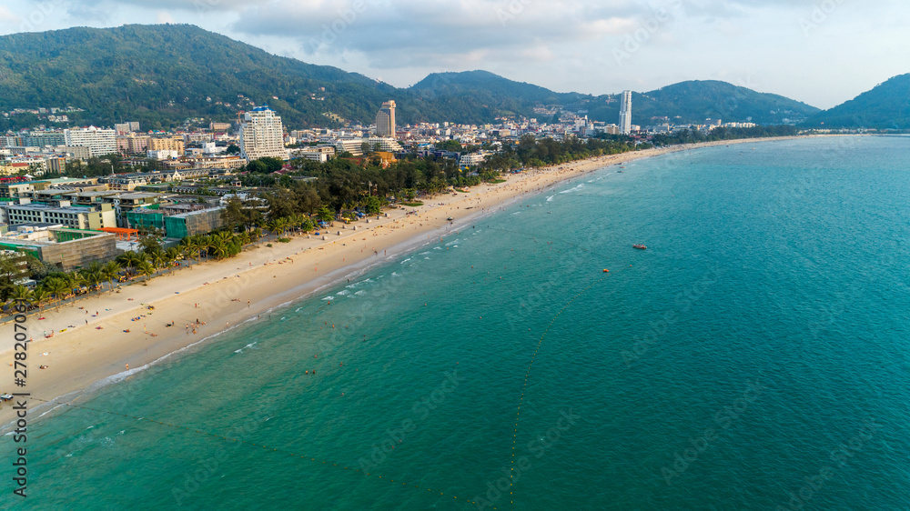Beautiful wave crashing on sandy shore at patong beach in phuket thailand,aerial view drone shot