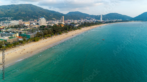 Beautiful wave crashing on sandy shore at patong beach in phuket thailand,aerial view drone shot