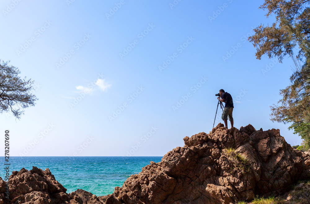 Professional photographer taking a picture of landscape scenery nature seascape view