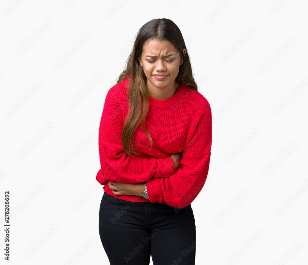 Young beautiful brunette woman wearing red winter sweater over isolated background with hand on stomach because nausea, painful disease feeling unwell. Ache concept. Young beautiful brunette woman wearing red winter sweater over isolated background with hand on stomach because nausea, painful disease feeling unwell. Ache concept.