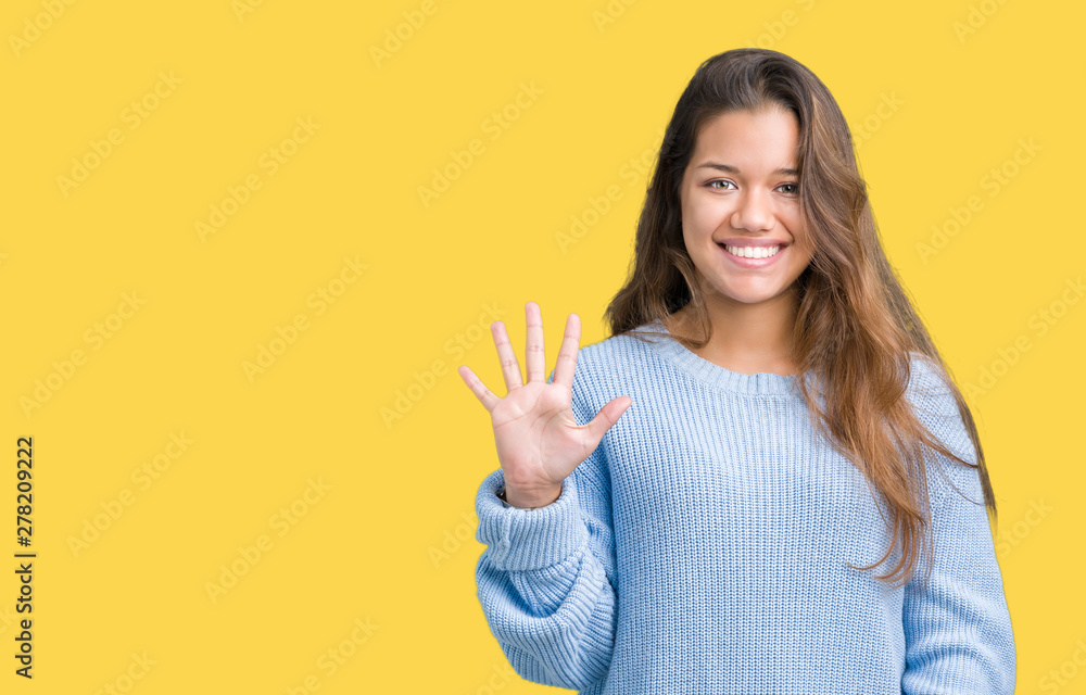Young beautiful brunette woman wearing blue winter sweater over isolated background showing and pointing up with fingers number five while smiling confident and happy. Young beautiful brunette woman wearing blue winter sweater over isolated background showing and pointing up with fingers number five while smiling confident and happy.