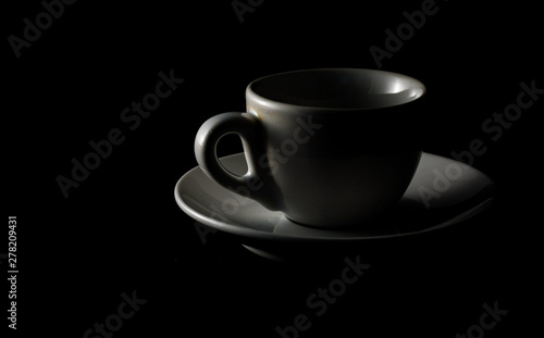 Isolated cup of coffee on black background