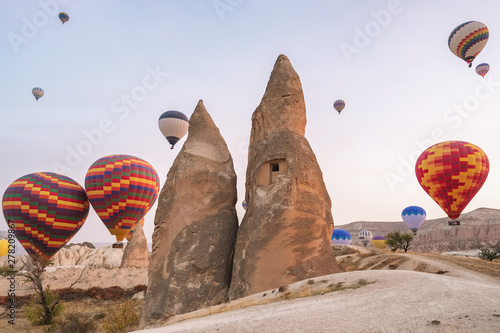Hot air balloons flying over the famous landscape of Cappadocia, Turkey